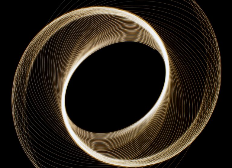 Dynamic light trails in circular form creating an abstract geometric pattern against a black background.